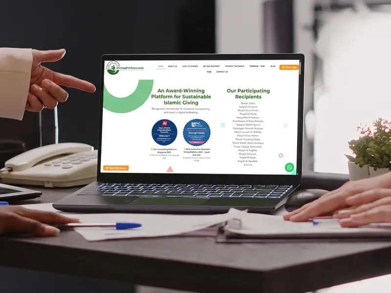 GivingFridays homepage on a laptop with award badges and participating recipients