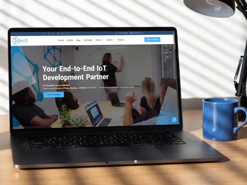 Oxit website hero on a laptop, presenting end-to-end IoT development