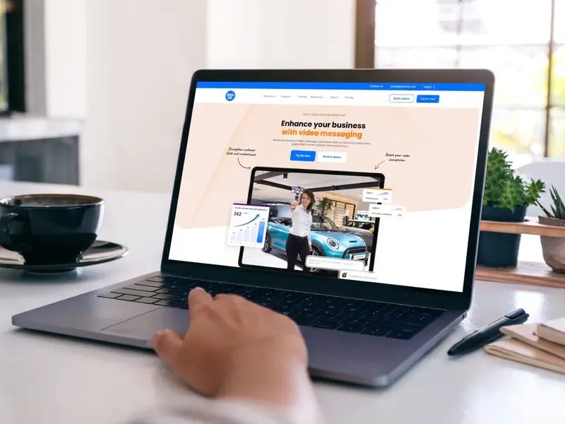 VentaVid homepage on a laptop, showing a salesperson recording a personalized vehicle video